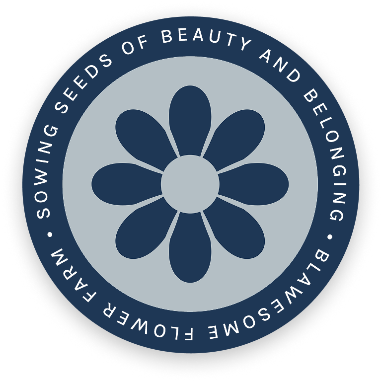 A circular logo with a stylized dark blue flower in the center, surrounded by the text: Sowing Seeds of Beauty and Belonging • Blawesome Flower Farm on a dark blue outer ring.